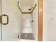 Shower with glass door, tile surround, built-in bench, and bronze fixtures at 28065 Camel Heights Cir, Evergreen, CO 80439
