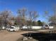 Backyard area with multiple structures and vehicle at 7486 Patrick St, Fort Lupton, CO 80621