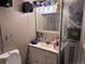 Small bathroom with a sink, mirror cabinet, and a shower with a plastic cover at 7486 Patrick St, Fort Lupton, CO 80621
