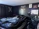 Bedroom with a bed and dark accents, offering a cozy and stylish space for rest and relaxation at 7486 Patrick St, Fort Lupton, CO 80621