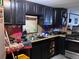 Functional kitchen featuring dark cabinetry, stainless steel appliances, and ample counter space, ideal for meal preparation and cooking at 7486 Patrick St, Fort Lupton, CO 80621