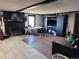 Inviting living room showcasing a fireplace, laminate flooring, and an entertainment center, perfect for Gathering gatherings and relaxation at 7486 Patrick St, Fort Lupton, CO 80621