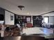 Spacious living room with fireplace, seamlessly connected to the dining area and providing an open floor plan for entertaining at 7486 Patrick St, Fort Lupton, CO 80621