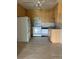 The kitchen has neutral cabinets, white appliances, and neutral floors at 9335 E Center Ave # 7C, Denver, CO 80247