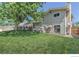 Large backyard with green lawn and mature trees creating a peaceful setting at 10560 W 102Nd Pl, Broomfield, CO 80021