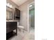 Bathroom featuring dark vanity with drawers and an adjoining shower area at 10560 W 102Nd Pl, Broomfield, CO 80021
