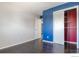 Bedroom with closet, a large window, painted accent wall, and hardwood floors at 10560 W 102Nd Pl, Broomfield, CO 80021