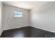 Bedroom showing clean, painted walls, a bright window, and solid wood flooring at 10560 W 102Nd Pl, Broomfield, CO 80021