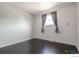 Bedroom showing a window with curtains, painted walls, and dark hardwood floors at 10560 W 102Nd Pl, Broomfield, CO 80021