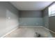Empty garage showing a bright window, freshly painted walls, and a concrete floor at 10560 W 102Nd Pl, Broomfield, CO 80021