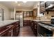 Modern kitchen with dark cabinets, stainless steel appliances, and countertop island at 10560 W 102Nd Pl, Broomfield, CO 80021