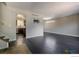 Spacious living room featuring dark wood floors, modern fixtures and access to the kitchen at 10560 W 102Nd Pl, Broomfield, CO 80021