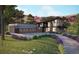 Contemporary home with a spacious driveway, three-car garage and manicured landscaping at 7935 Dante Dr, Littleton, CO 80125
