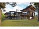 Stunning modern home showcasing balconies, expansive windows, and lush green surroundings at 7935 Dante Dr, Littleton, CO 80125