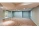 Large finished basement area with neutral walls and carpet at 12388 E Caspian Dr, Aurora, CO 80014