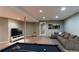 Finished basement area with sofa, TV, and pool table at 12388 E Caspian Dr, Aurora, CO 80014