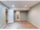 Finished basement space with carpeting and a doorway to another room at 12388 E Caspian Dr, Aurora, CO 80014