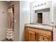 Bathroom with vanity, shower with curtain, and mirror with lighting at 12388 E Caspian Dr, Aurora, CO 80014
