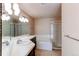 Bright bathroom featuring a double vanity, a soaking tub, and a glass-enclosed shower at 12388 E Caspian Dr, Aurora, CO 80014
