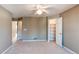 Neutral bedroom featuring carpet, ceiling fan, and an open closet at 12388 E Caspian Dr, Aurora, CO 80014