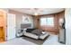 Stylish bedroom featuring a ceiling fan, a large window, and elegant decor at 12388 E Caspian Dr, Aurora, CO 80014