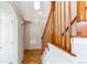 Bright entryway features hardwood floors, a staircase with wooden railings, and a high ceiling at 12388 E Caspian Dr, Aurora, CO 80014