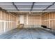 Unfinished garage with concrete floor and drywall walls at 12388 E Caspian Dr, Aurora, CO 80014