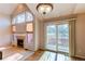 Bright living space featuring a fireplace, large windows, and a sliding door to the outdoor area at 12388 E Caspian Dr, Aurora, CO 80014