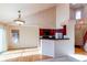 Open living space featuring hardwood floors, high ceilings, and bar seating near the kitchen at 12388 E Caspian Dr, Aurora, CO 80014
