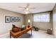 Comfortable home office featuring a large desk, a ceiling fan, and a window for natural light at 12388 E Caspian Dr, Aurora, CO 80014