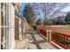 Inviting patio area with stucco walls and a charming red fence, perfect for relaxing outdoors at 12388 E Caspian Dr, Aurora, CO 80014