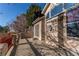 Beautiful outdoor patio with stucco walls, a red fence, and a secure gated entrance at 12388 E Caspian Dr, Aurora, CO 80014