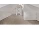 Finished attic with neutral carpet, offering potential as a playroom or extra living space at 30 Fox St, Denver, CO 80223