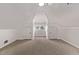 Finished attic with carpet and storage closets with a dormer window for natural light at 30 Fox St, Denver, CO 80223