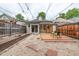 Private backyard retreat featuring gravel, stepping stones, wooden deck, and detached garage at 30 Fox St, Denver, CO 80223