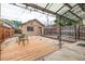 Secluded backyard featuring a wooden deck and detached garage with a unique design at 30 Fox St, Denver, CO 80223