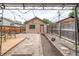 Landscaped backyard with a deck, gravel, and a charming building with dark trim at 30 Fox St, Denver, CO 80223