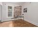 A bedroom showcasing wood floors, a brick accent wall, and a modern desk at 30 Fox St, Denver, CO 80223