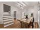 Dining area features a rustic wooden table, white walls, and hardwood floors at 30 Fox St, Denver, CO 80223