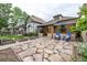 Charming home with stone pathway leading to a welcoming porch with blue chairs, and well-maintained yard at 30 Fox St, Denver, CO 80223