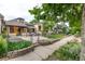 A charming home featuring raised garden beds and an inviting stone patio at 30 Fox St, Denver, CO 80223