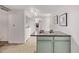 A kitchen view including an island, appliances, white walls and open access to a laundry and bath at 30 Fox St, Denver, CO 80223
