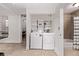 Laundry room and adjoining bath space, featuring modern washer/dryer and storage shelves at 30 Fox St, Denver, CO 80223