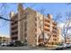Attractive condo building with stone and brown siding plus multiple balconies at 252 N Pennsylvania St # 305, Denver, CO 80203