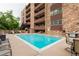 Community pool with a well-maintained deck area, chairs and a barbeque at 252 N Pennsylvania St # 305, Denver, CO 80203