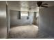 An empty bedroom, features carpet, windows, and ceiling fan at 8 S Kendall St, Lakewood, CO 80226