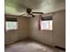Bedroom features a ceiling fan and two windows with curtains at 8 S Kendall St, Lakewood, CO 80226