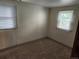 Neutral bedroom featuring carpet and two windows with window coverings at 8 S Kendall St, Lakewood, CO 80226