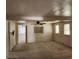 Open living room features a ceiling fan, two windows, and an open doorway at 8 S Kendall St, Lakewood, CO 80226