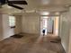 Living room features a ceiling fan and a dog walking toward an open door at 8 S Kendall St, Lakewood, CO 80226